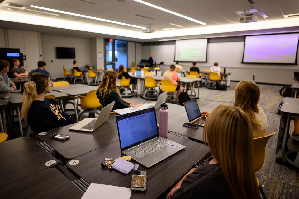 a modern classroom setting with students engaged in a lecture.